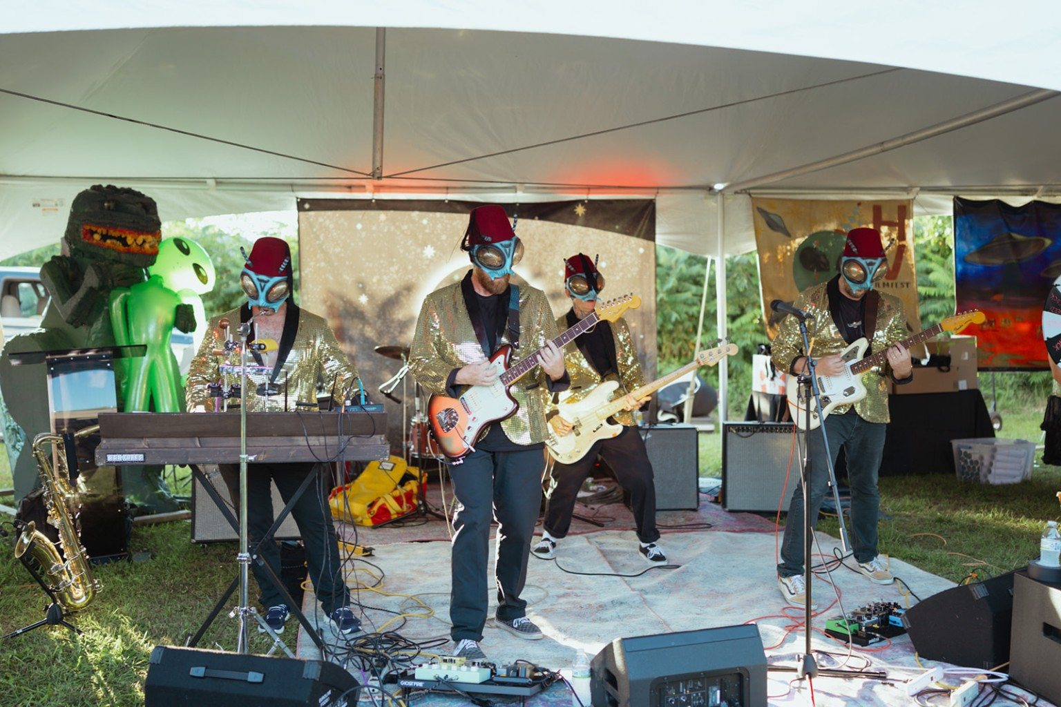 The Sci-Flies performing live under a tent